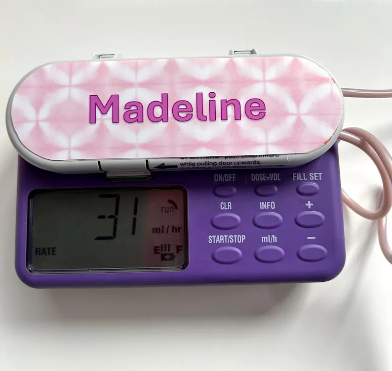 Flower Check Name sticker on a feeding tube pump