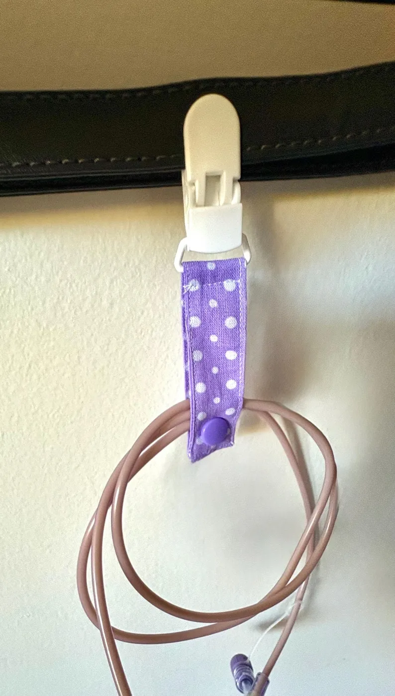 Tubie Clips sticker on a feeding tube pump